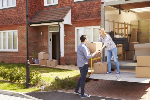 Professional movers carefully wrapping furniture before loading