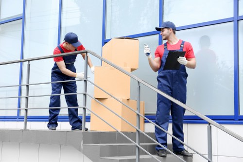 Professional team handling office furniture and equipment during an Enfield move