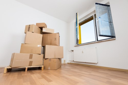 Packed office boxes and labelled furniture ready for transport