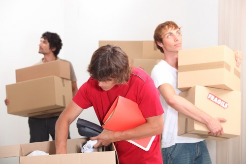 Family preparing for home relocation in Enfield with labelled boxes